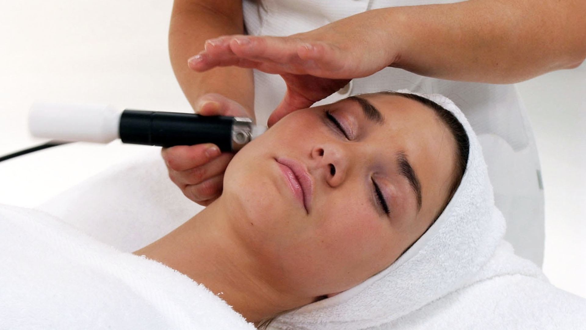Microdermabrasion treatment being performed
